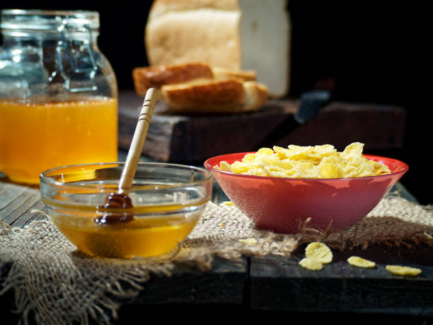 A portion of cornflakes with honey for breakfast